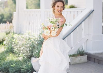 bride with bouquet front steps